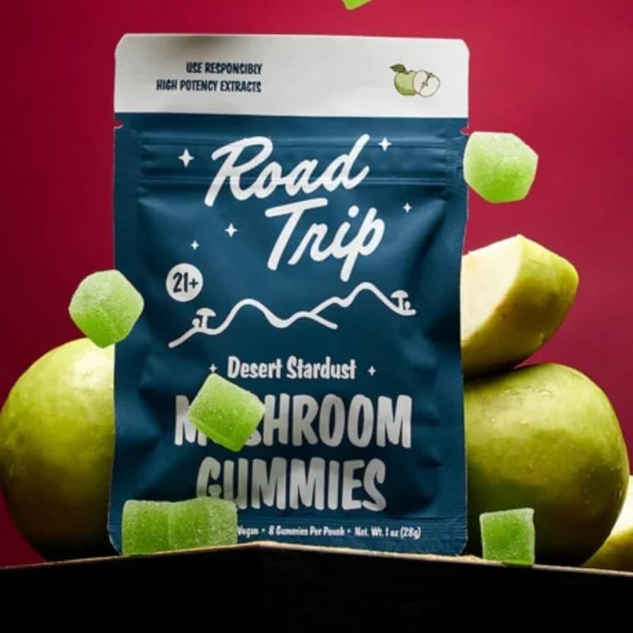 Road Trip Desert Stardust Mushroom Gummies pack with green apple backdrop, featuring 8 vegan, nootropic gummies.