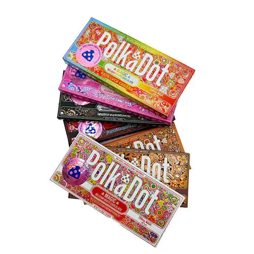 Stack of colorful PolkaDot chocolate bars showcasing vibrant packaging designs and flavors.