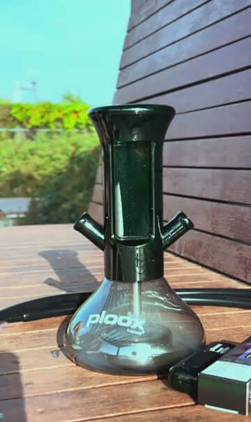 Ploox X G2 Portable Hookah with sleek design on a wooden surface, showcasing its modern features and dual-hose capability.